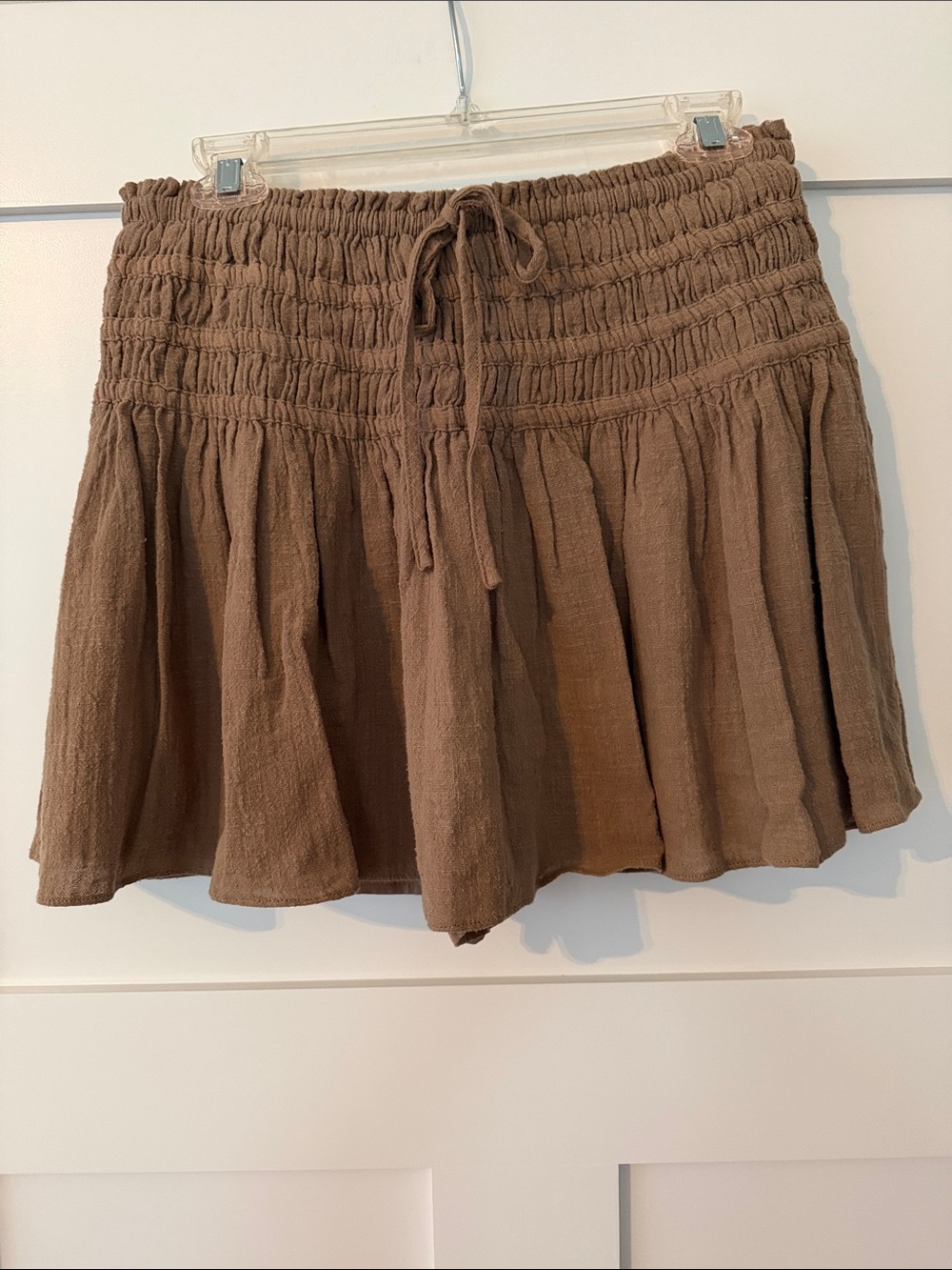 Tan colored elastic drawstring waisted skirt with built in shorts